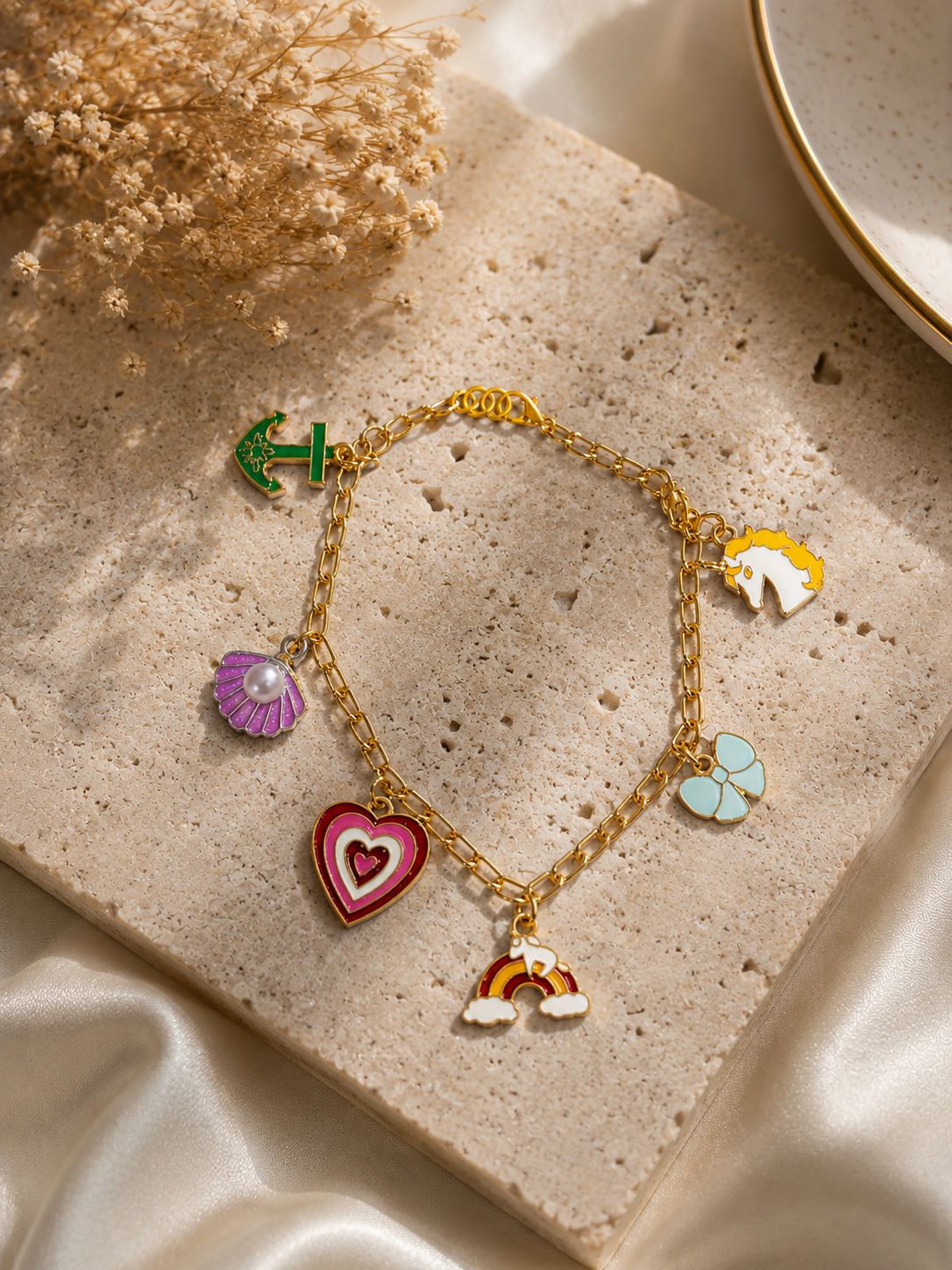 Colorful charm bracelet with gold-tone chain and cute enamel charms